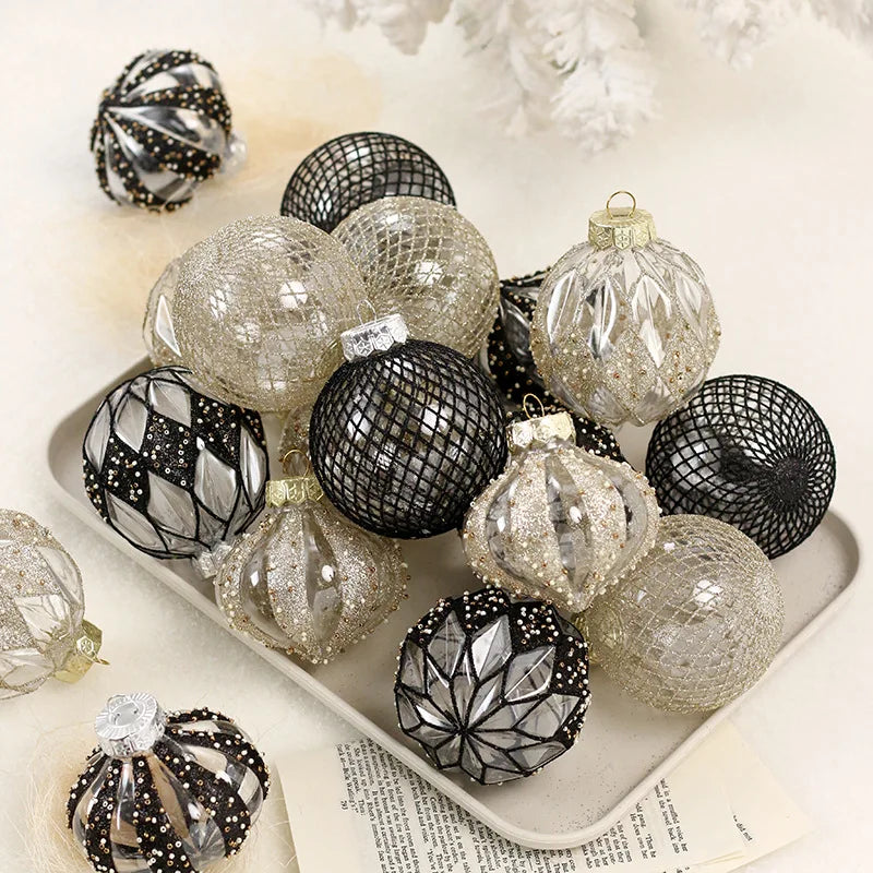 Nordic Noel Christmas baubles in black, silver, and champagne gold finishes arranged on a neutral tray - elegant mixed-texture ornaments for refined festive décor