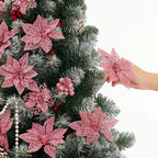 Blush pink glitter poinsettias and berry stems styled through a Christmas tree - soft pastel festive décor with Kitschmas charm