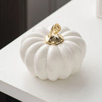 Gold-stem pumpkin ornament close-up – glossy ceramic finish
