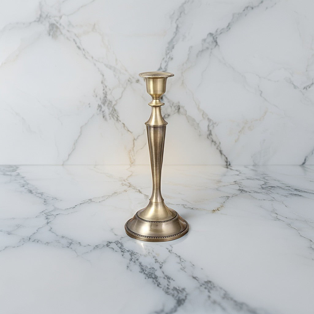 Elegant brass gold taper candle holder in metallic finish for festive interiors