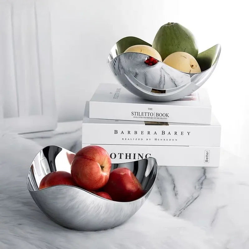 Sculpted stainless-steel wave bowl with fruit on marble surface – Maison Mistletoe Nordic Noel decor