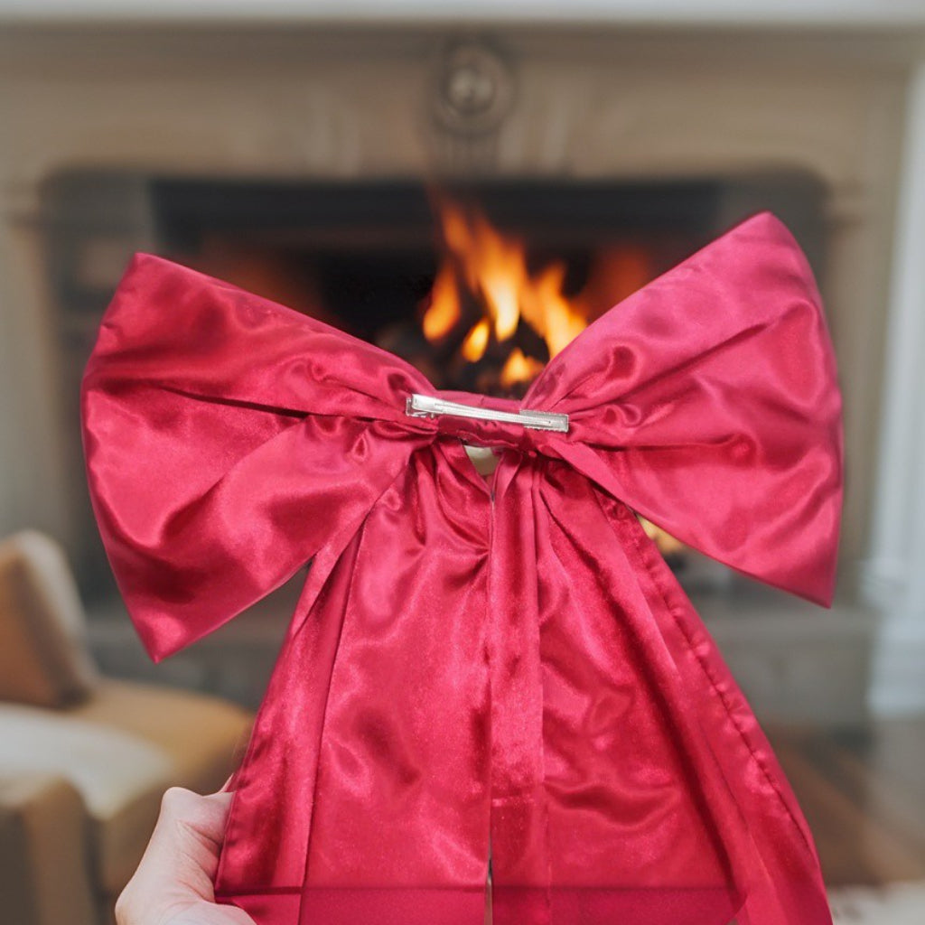 Oversized 120cm red satin bow Christmas tree topper with long cascading tails, luxury festive decoration for trees, staircases, doors, and fireplaces