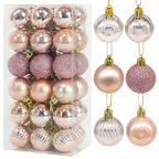 Set of rose gold Christmas baubles in assorted finishes - matte, glitter, and metallic - presented in clear packaging for elegant festive styling